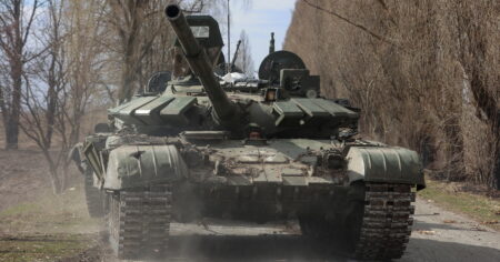 image-ukrainian-service-member-drives-a-captured-russian-t-72-tank-in-lukianivka